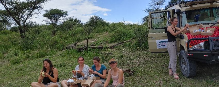 Smiling guests pose for a memorable photo on safari with Sereti Wilderness Safaris, capturing the spirit of adventure and the breathtaking. - Sereti Safaris