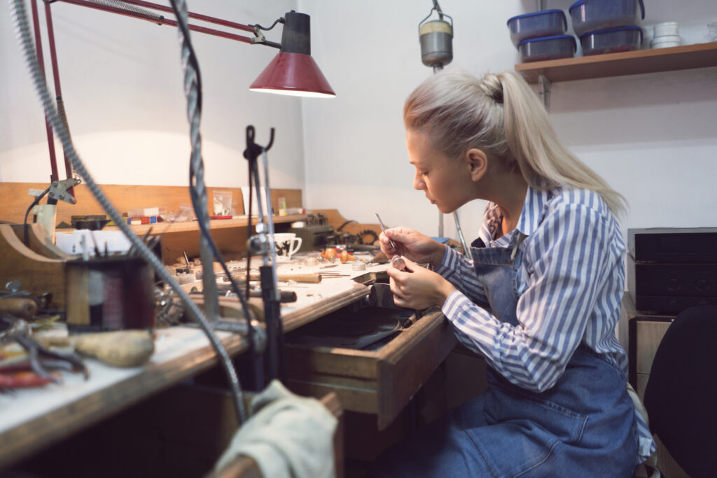 Female jeweller working late at her workshop.