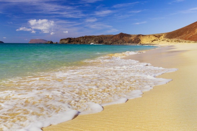 Amateur beach nudists stretching on the golden sand