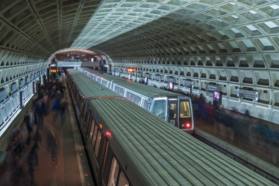 Two trains stop for passengers at metro stop in interesting architecturally designed underground tunnel at Union Station in Washington D.C. (© shakzu))